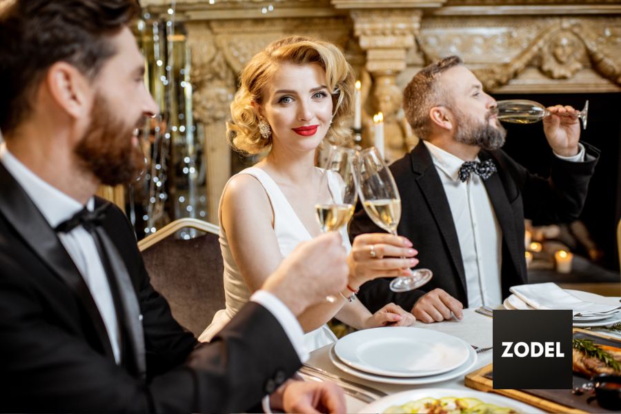 Woman at formal dinner making a formal toast, learned from etiquette classes.